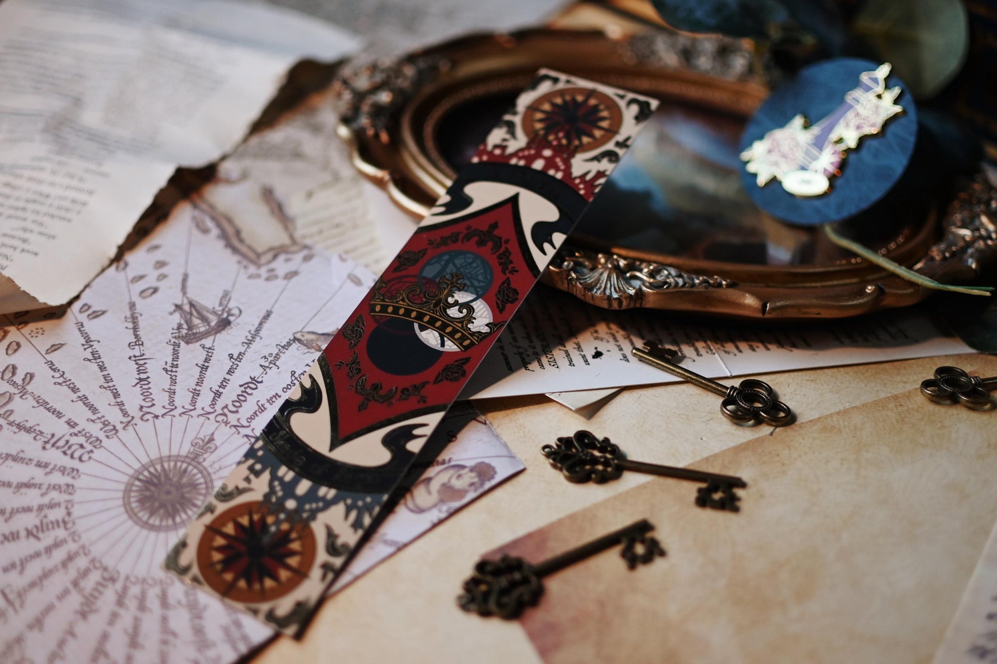 A Darker Shade of Magic book spine bookmark propped up featuring the full design with the delicate gold foil detailing. 