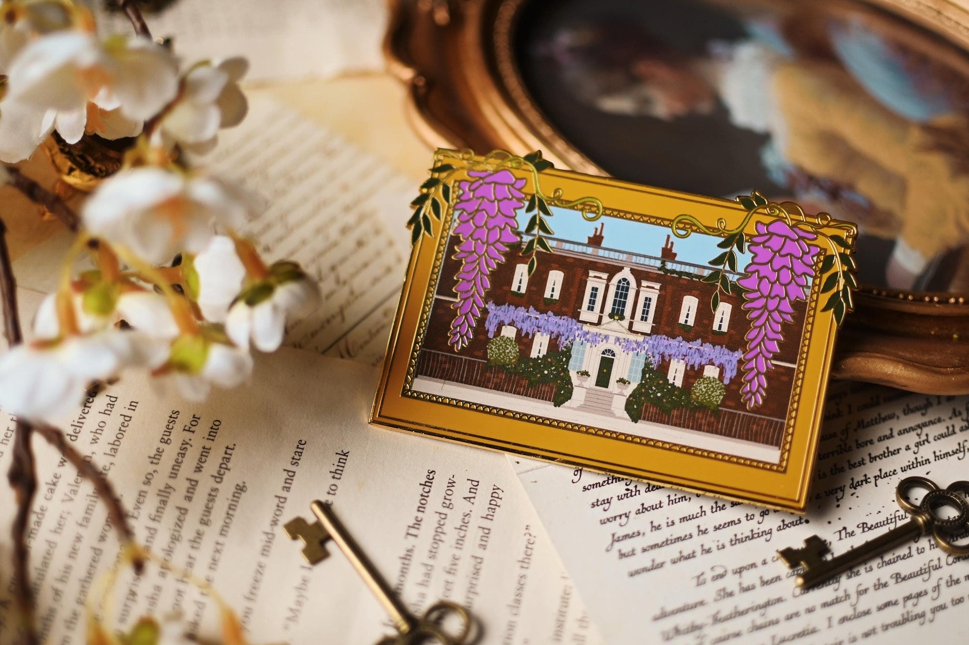 An enamel pin featuring an illustration of Bridgerton House with purple flowers and a yellow frame, placed on a surface with a vintage aesthetic.