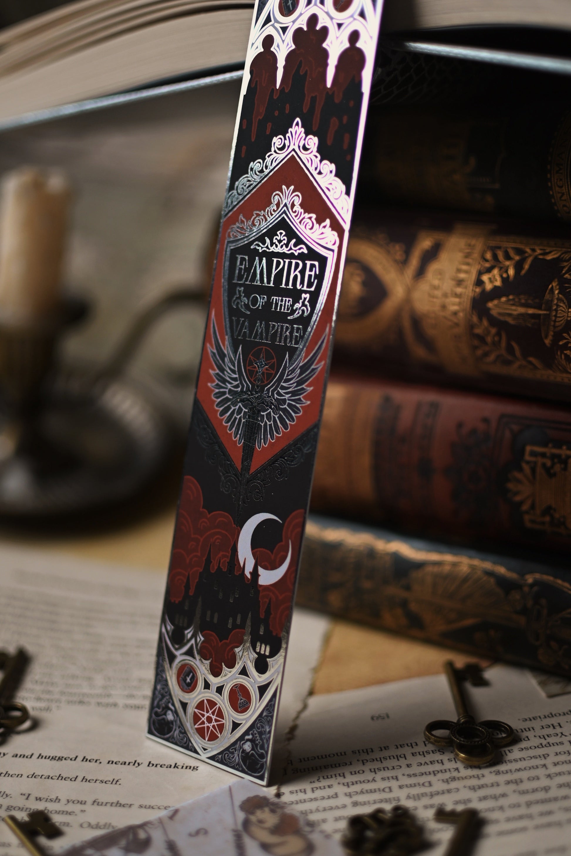 Decorative bookmark with 'Empire of the Vampire' design on a book and candle background