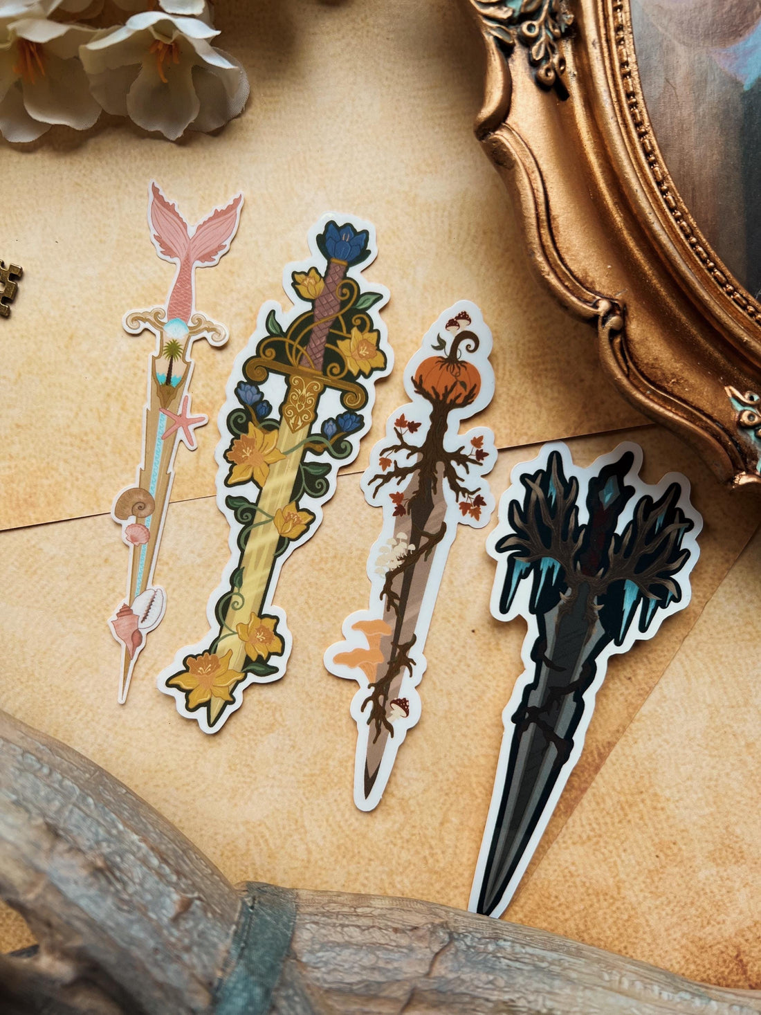 A variety of decorative stickers with floral and animal patterns displayed on a surface with a vintage frame and antlers in the background.