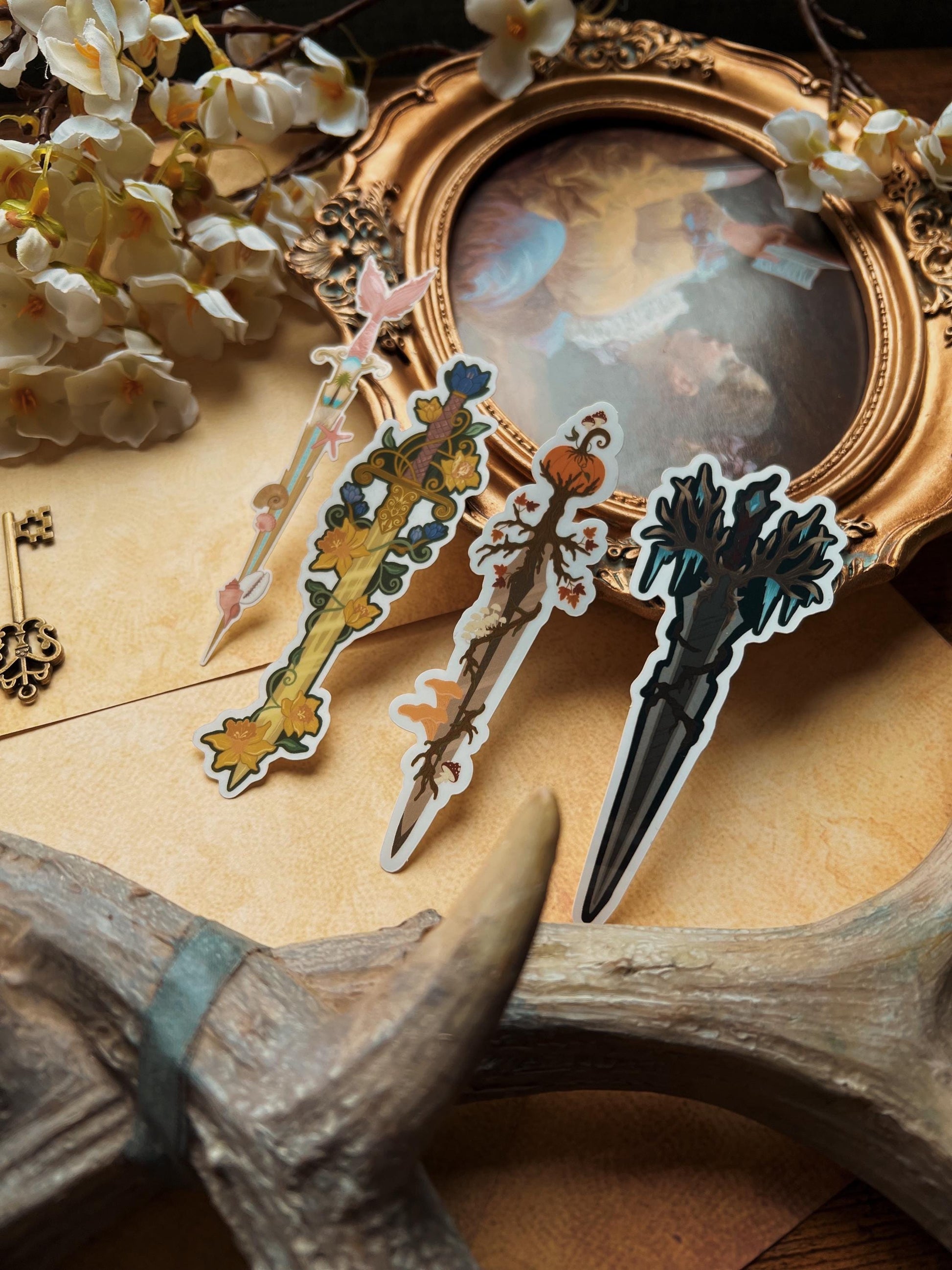 A variety of decorative stickers with floral and animal patterns displayed on a surface with a vintage frame and antlers in the background.