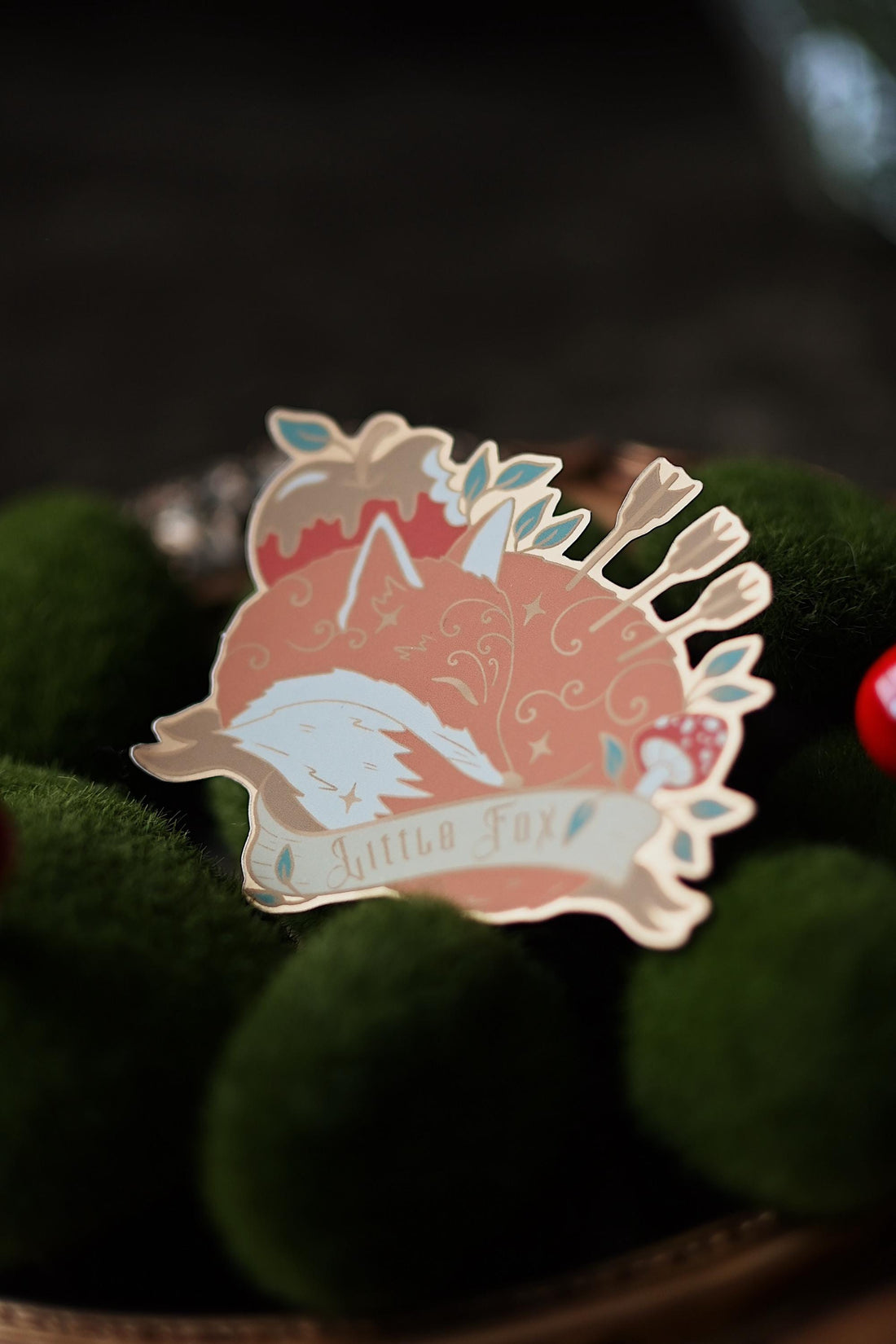 A foiled matte sticker depicting a character and a fox with a ribbon with 'Little Fox'.