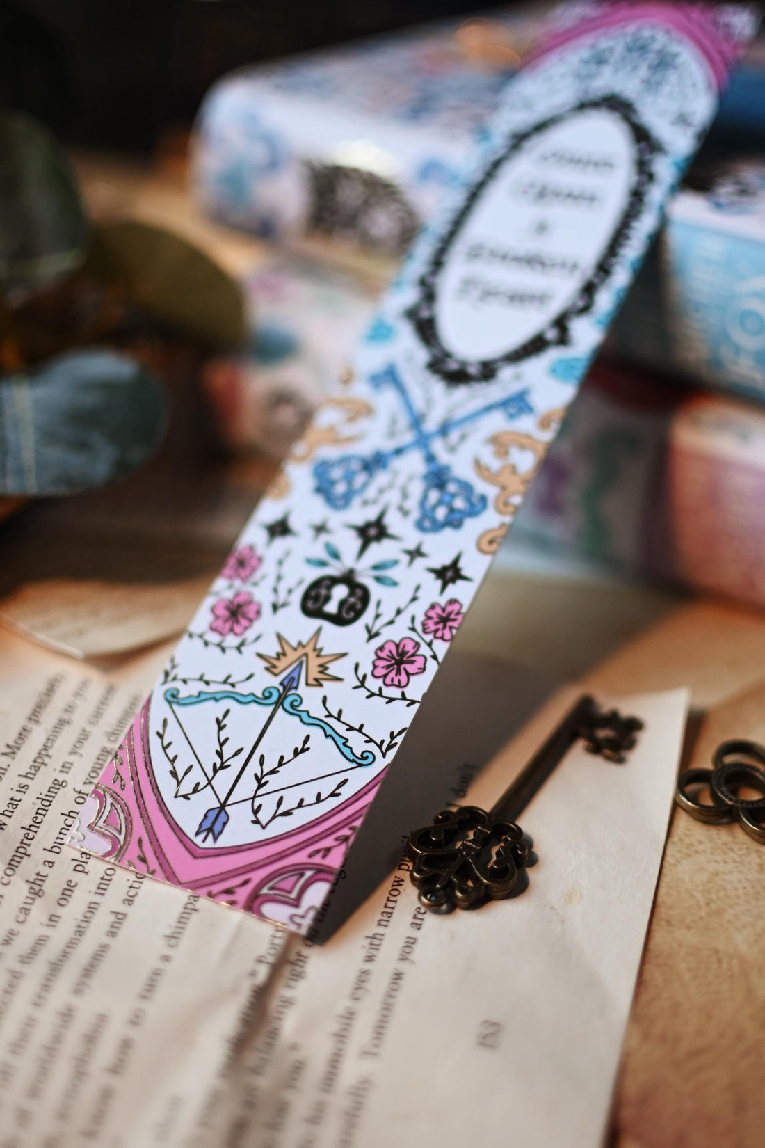 Inspired by the books by Stephanie Garbar, the Once Upon a Broken Heart bookspine bookmark rests against a background of the books, bookpages and propped up by a mirror. 